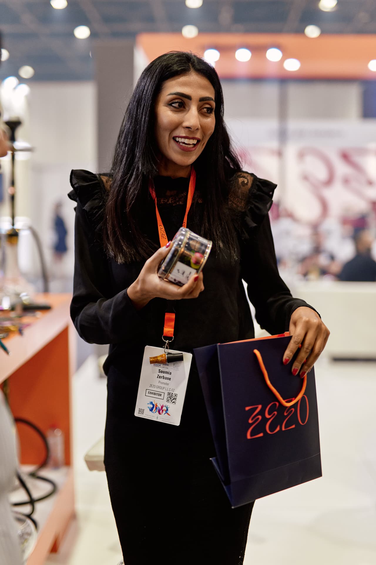 Product hand detail with ZEZO bag and booth styling